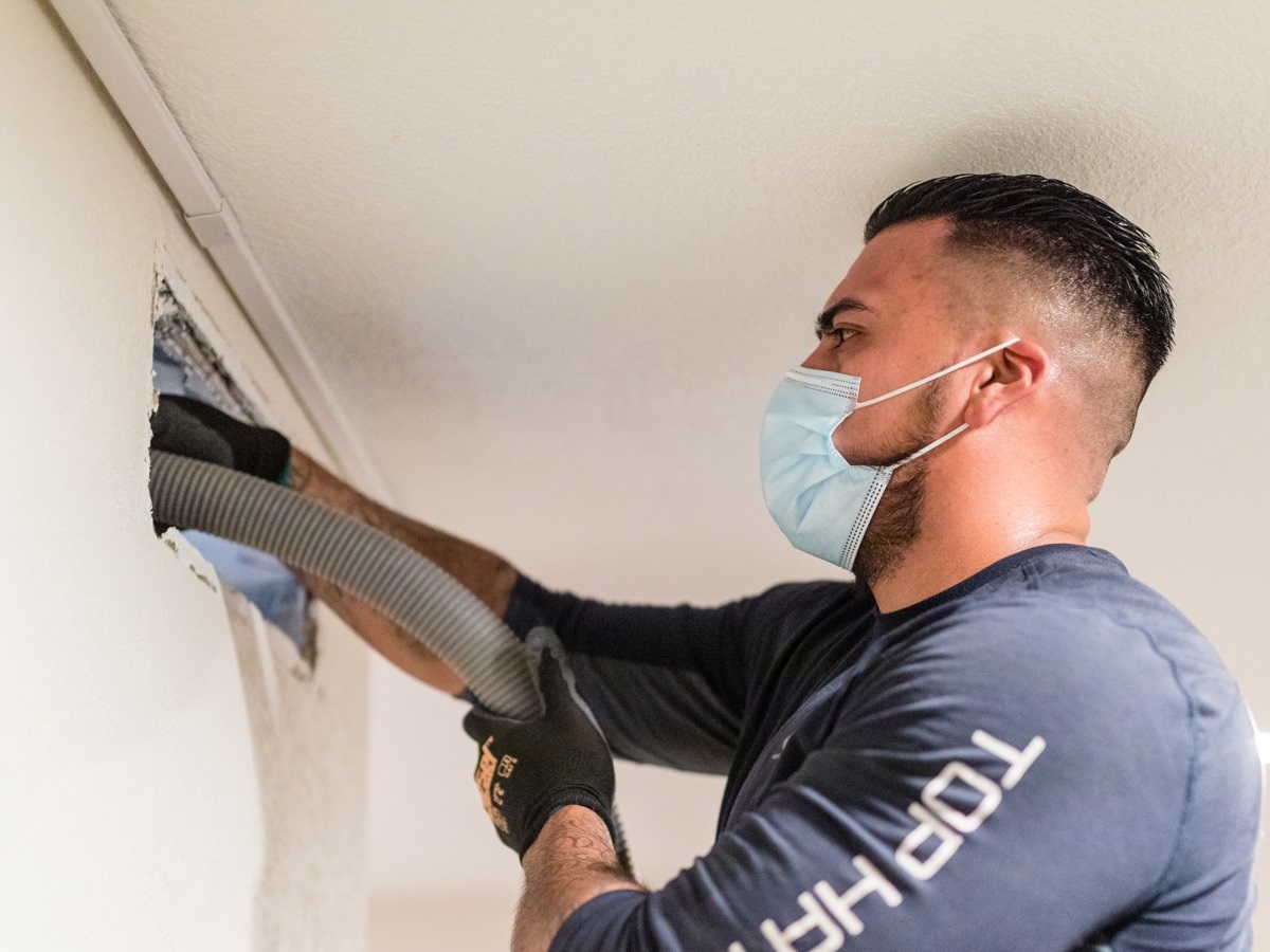 Close up cleaning air vent 2 Cropped top hatter professional service technicians